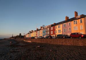 a row of buildings on the side of a street at Stunning Aberystwyth South Beach Apartment in Aberystwyth