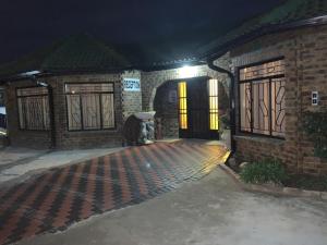 an entrance to a house at night at Sikhula Sonke Guest House in Erasmus