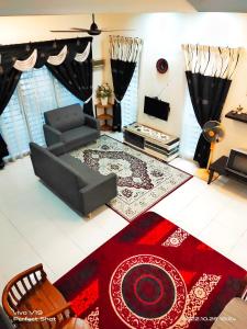 a living room with a couch and a television at Sweet40 Homestay in Kampong Batu Lapan