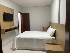 Säng eller sängar i ett rum på Mauri Center Hotel