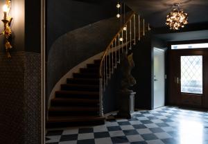 a staircase in a house with a checkered floor at Villa Weber - self check-in in Aarburg