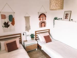 a bedroom with two beds and a table at Casa Encanto in Lajares +36 photos