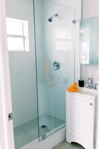 a bathroom with a shower with a glass door at Casa Cordova By Lowkl in Fort Lauderdale