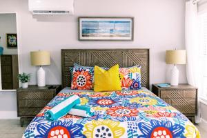 a bedroom with a large bed with colorful pillows at Casa Cordova Apartments By Lowkl in Fort Lauderdale