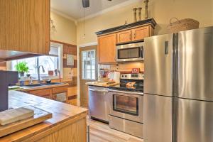 a kitchen with a stainless steel refrigerator and wooden cabinets at Spacious Victorian Home quarter Mi to Holiday Valley! in Ellicottville