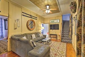 a living room with a couch and a ceiling fan at Spacious Victorian Home quarter Mi to Holiday Valley! in Ellicottville