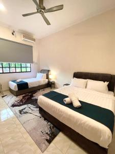a bedroom with two beds and a ceiling fan at Villa Ruby - with private swimming pool in Kota Bharu +50 photos