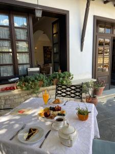 a table with a plate of food on it at Boutique Hotel Muzaka (Historic Center) in Berat