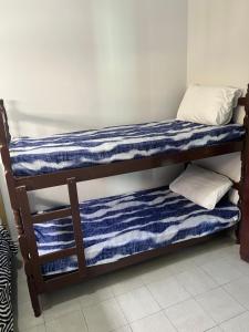 Vila Itanhaém客房内的一张或多张床位