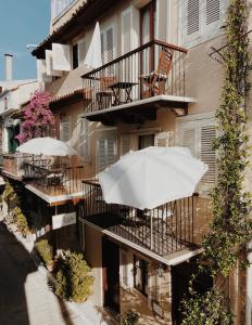 a white umbrella sitting on the balcony of a building at Five Seasons Pension in Nafplio