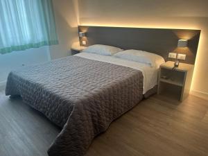 Postel nebo postele na pokoji v ubytování Hotel Friuli