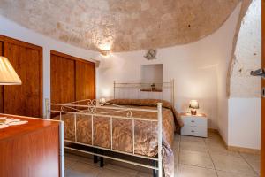 a bedroom with a bed in a room at Trulli da Tommaso - Martina Franca in Martina Franca