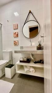 a bathroom with a sink and a mirror at Pousada Casa Mariscal in Bombinhas