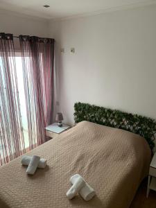 a bedroom with a bed with two pillows on it at Casa Da Baixa in Faro