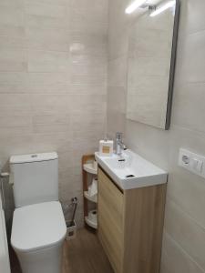 a bathroom with a toilet and a sink and a mirror at Piso Acondicionado in Cartagena +10 photos