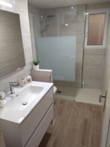 a bathroom with a white sink and a shower at Piso Acondicionado in Cartagena