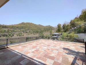 a large patio with a view of a mountain at Dehradun Beautiful new private cottage with Kitchen in the Hills in Dehradun