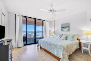 a bedroom with a bed and a view of the ocean at Crescent Beach Club I 5A in Clearwater Beach