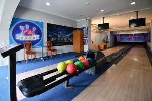 a bowling alley with balls on a lane in a room at Ośrodek Chrobry in Pokrzywna
