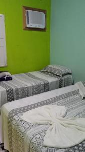 Uma cama ou camas num quarto em Pousada Casa da Neuzita