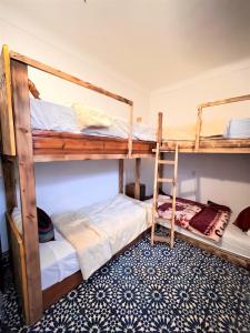two bunk beds in a room with a carpet at berber hostel in Essaouira