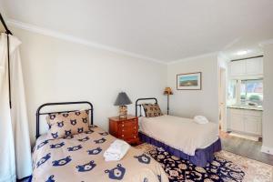 a bedroom with two beds and a window at Gentle Winds 21 22 in Glen Arbor