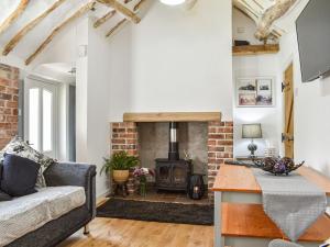 a living room with a fireplace and a couch at Chase Heys Cottage in Crossens