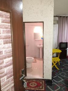 a small bathroom with a toilet and a sink at Mamaya Hotel in Amman