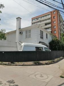 a white van parked in front of a building at HOSTAL SUZI in Santiago