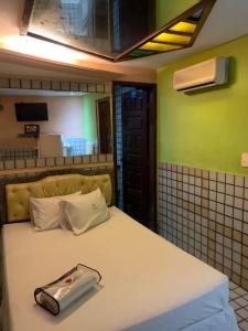 a room with a bed with a tray on it at Motel Estoril (Adult Only) in Recife