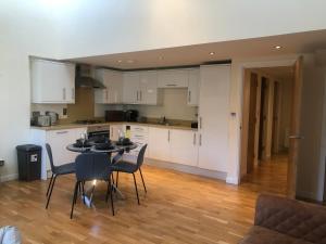 a kitchen and dining room with a table and chairs at Private Parking 2 Bed 2 bath in Edinburgh