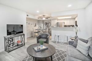a living room with a couch and a table with a fireplace at Chic Phoenix Condo Pool Access, Close to Hiking in Phoenix