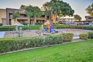 a park with a playground in front of a building at Chic Phoenix Condo Pool Access, Close to Hiking in Phoenix