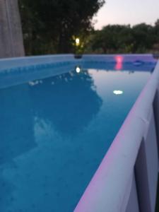 a large swimming pool with a blue liquid at Villa Gabri in Carlentini