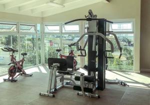 a gym with two exercise bikes in a room at Suite Retreat at The Lofts in Kingston
