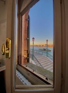 威尼斯的住宿－Al Ponte Lungo - Giudecca，享有码头景致的开放式窗户