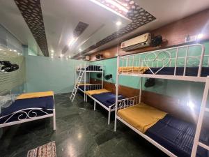 a room with several bunk beds in it at Backpackers hostel in Pune