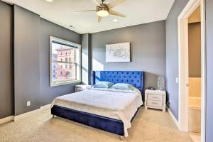 a bedroom with a blue bed and a window at Historical Apt in Dtwn Omaha - Pets Welcome! in Omaha