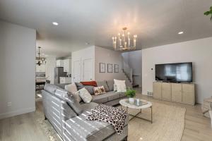 a living room with a couch and a tv at Lovely Vineyard Getaway Less Than 1 Mi to Utah Lake! in Vineyard
