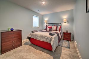 a bedroom with a bed and a dresser and a window at Family Home on Crystal Lake with Private Beach! in Hart