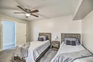 a bedroom with two beds and a ceiling fan at Modern Houston Gem about Walk to Minute Maid Park in Houston