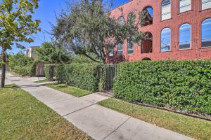 a sidewalk in front of a red brick building at Modern Houston Gem about Walk to Minute Maid Park in Houston