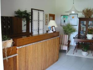 a lobby with a wooden counter and a room at Hotel Su Giudeu in Chia