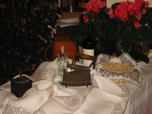 a table with two bottles of wine and flowers at Hotel Su Giudeu in Chia