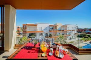 a table with food and drinks on a balcony at Terraços do Rio by CORAL in Portimão