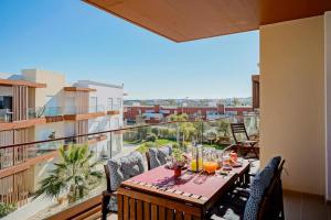 a balcony with a table and chairs and a view of the city at Terraços do Rio by CORAL in Portimão