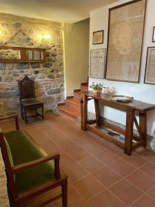 a room with a table and a table and a chair at Lo studio di Gabriella in Bolsena