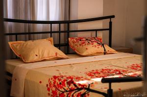 a bed with a black headboard and pillows on it at Or'Delice Residence in Antananarivo