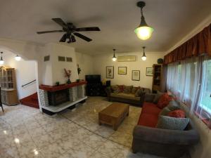 a living room with a couch and a fireplace at Tot&aacute;lis Harm&oacute;nia Villa in Miskolctapolca