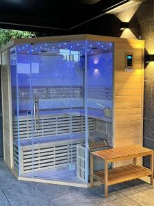 a shower stall with a bench in front of it at Les Suites du Lac in Aix-les-Bains